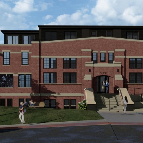 a brick building with a flag on the front